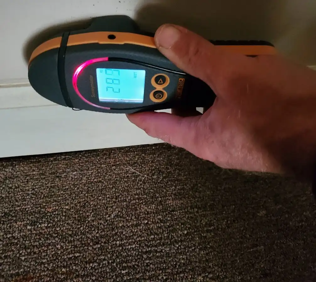Moisture detection at baseboard during Storm Damage Restoration in Garner